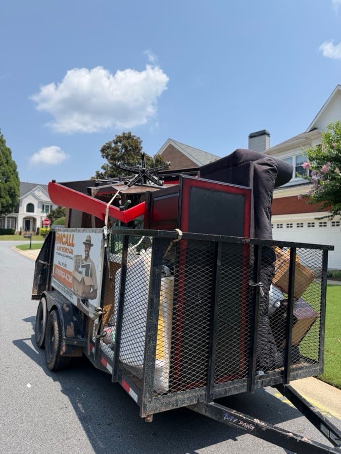 OnCall trailer loaded with a sofa, office chair, and furniture after a removal job